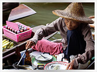 KL Floating Market woman selling food on the floating market in Kuala Lumpar, Malaysia